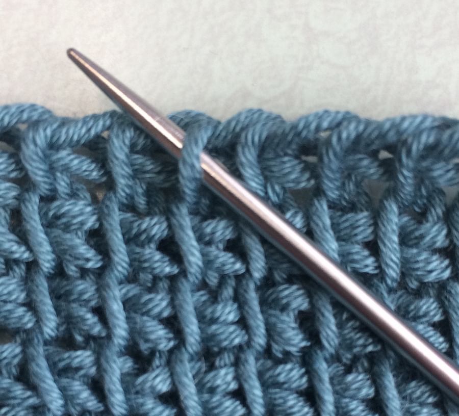 Close-up view of intricate Tunisian crochet stitch work